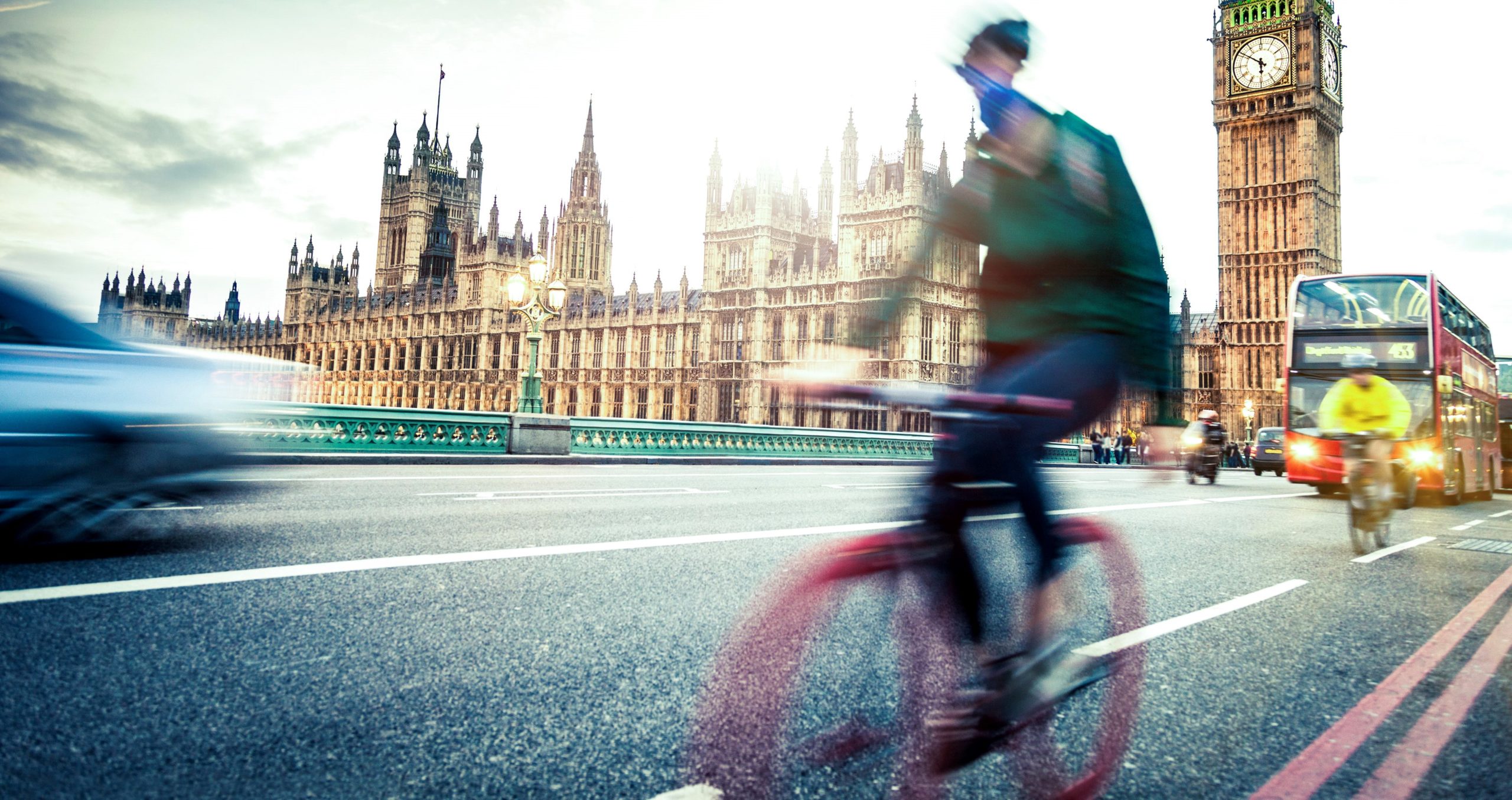 An image of people utilizing different commuting options in London, including cycling.